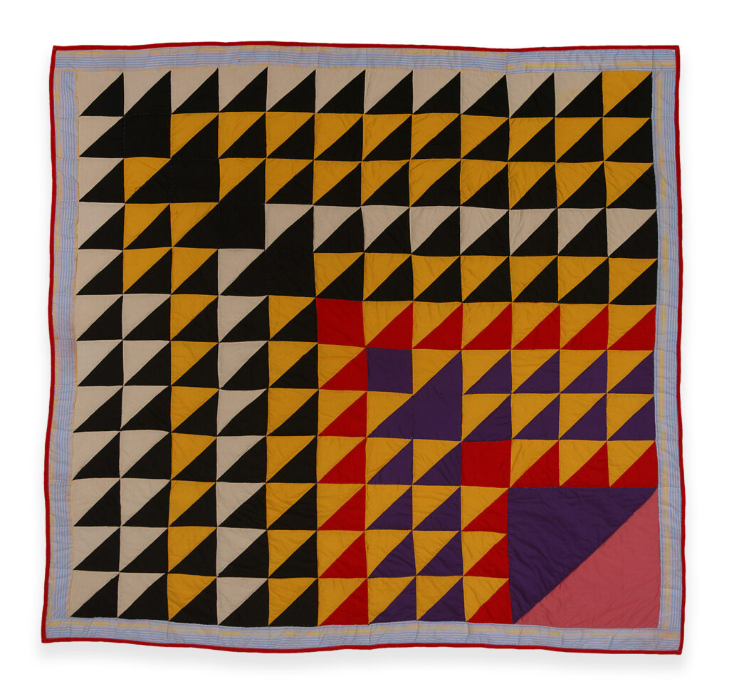 black, white, red and yellow triangles all pointing in the same direction - toward the lower right hand corner of this quilt.